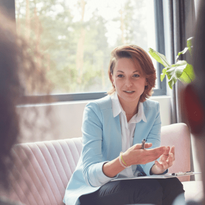 Female psychologist runs session with employees on their wellbeing